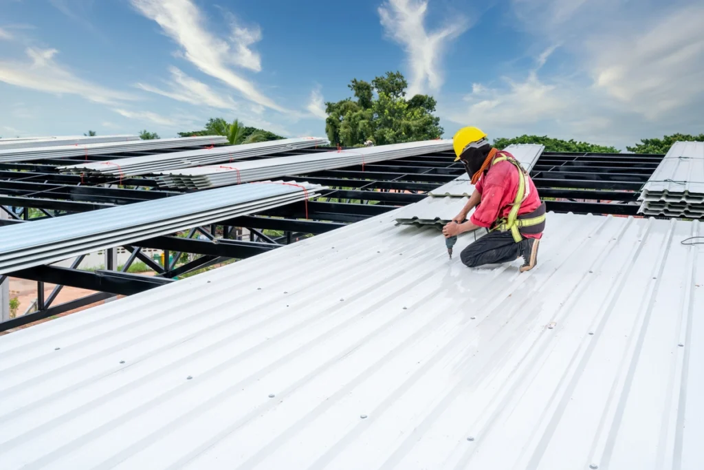 commercial roofing waunakee workers installing metal roof