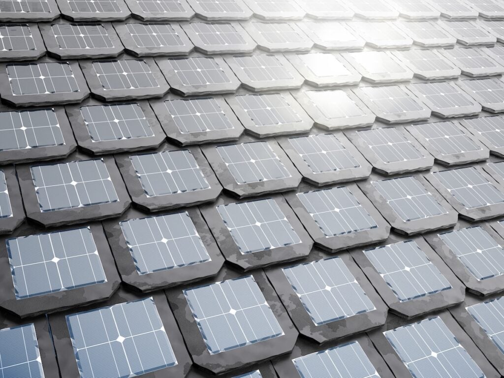 Close-up view of a rooftop covered with hexagonal solar shingles, reflecting sunlight and arranged in a neat, overlapping pattern to capture solar energy efficiently.