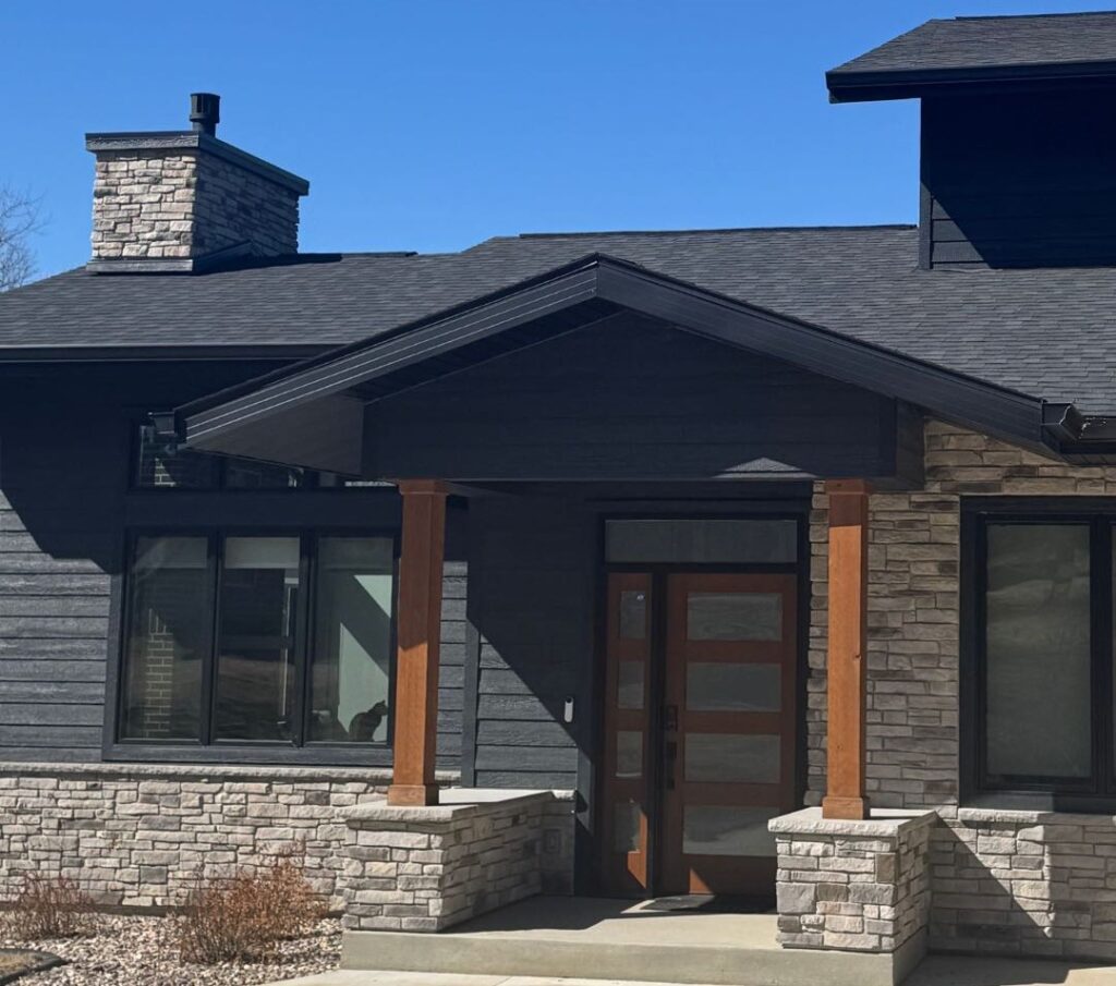 A house with a door and a porch, featuring quality roofing New Berlin homeowners trust.