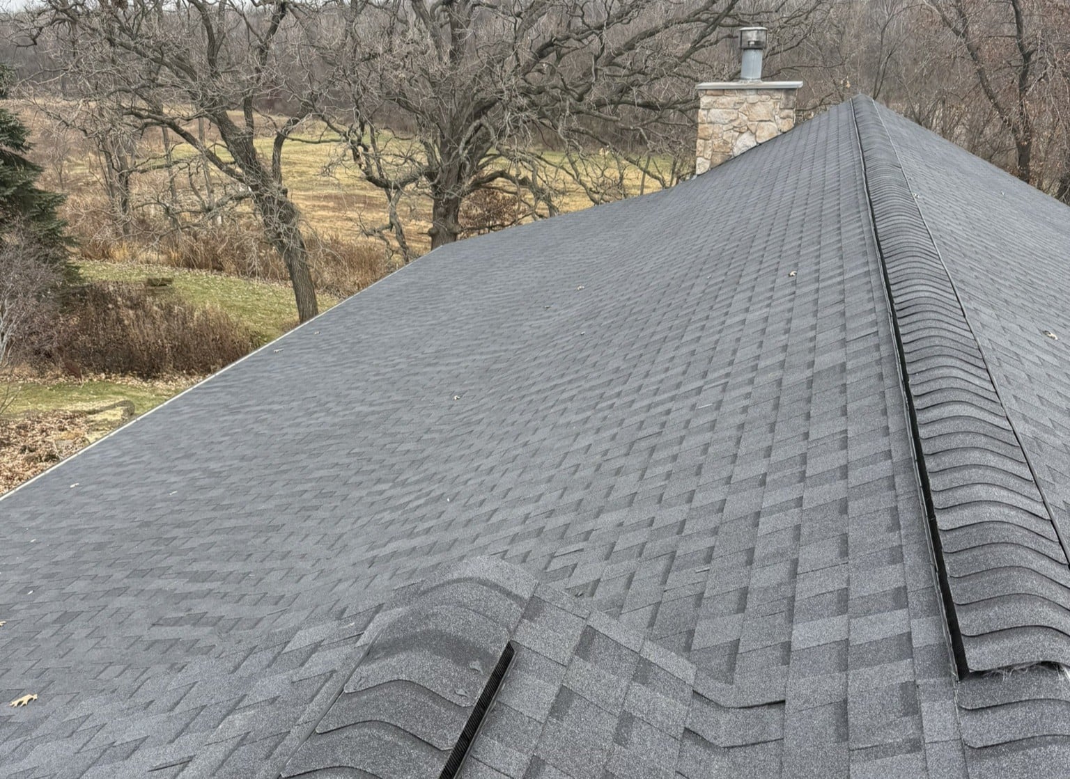A close-up view of a gray shingled house roof