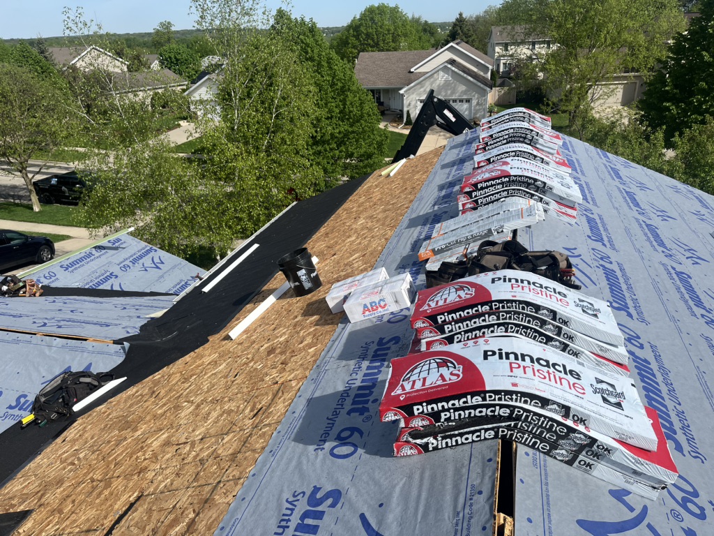 A rooftop under construction with roofing materials